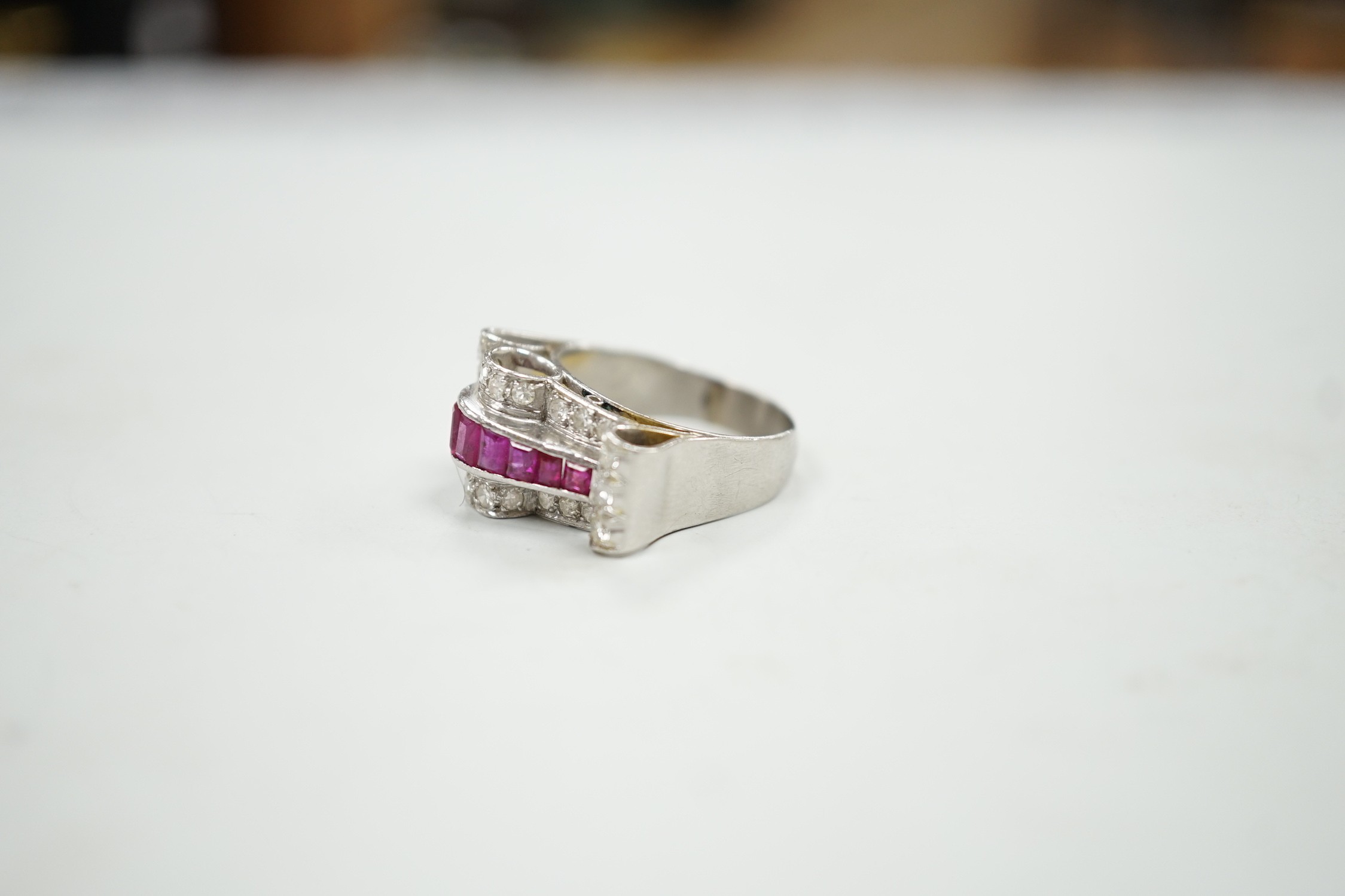 A 1950's? white metal, graduated ruby and diamond cluster set cocktail ring, size Q, gross weight 9.1 grams.